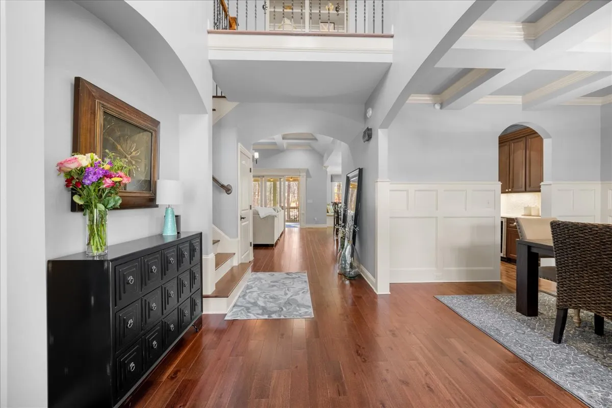 a living room with furniture a chandelier and a fireplace