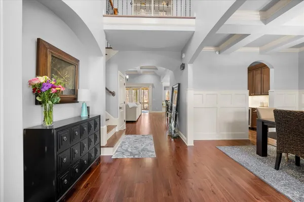 a living room with furniture a chandelier and a fireplace