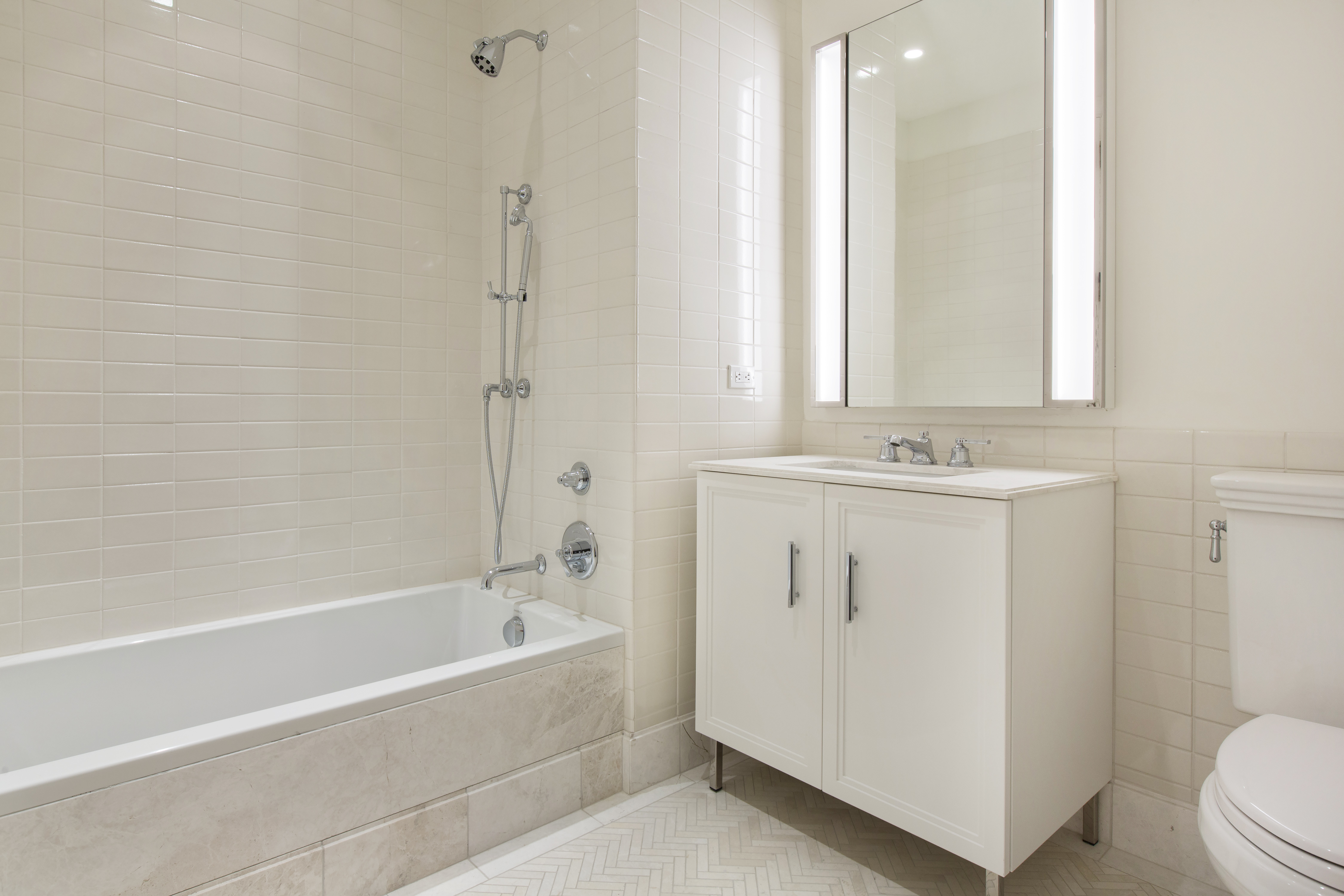 100 Barclay Street, Unit 14K Manhattan, NY 10007 - Photo 7 of 9 a bathroom with a sink a toilet and shower