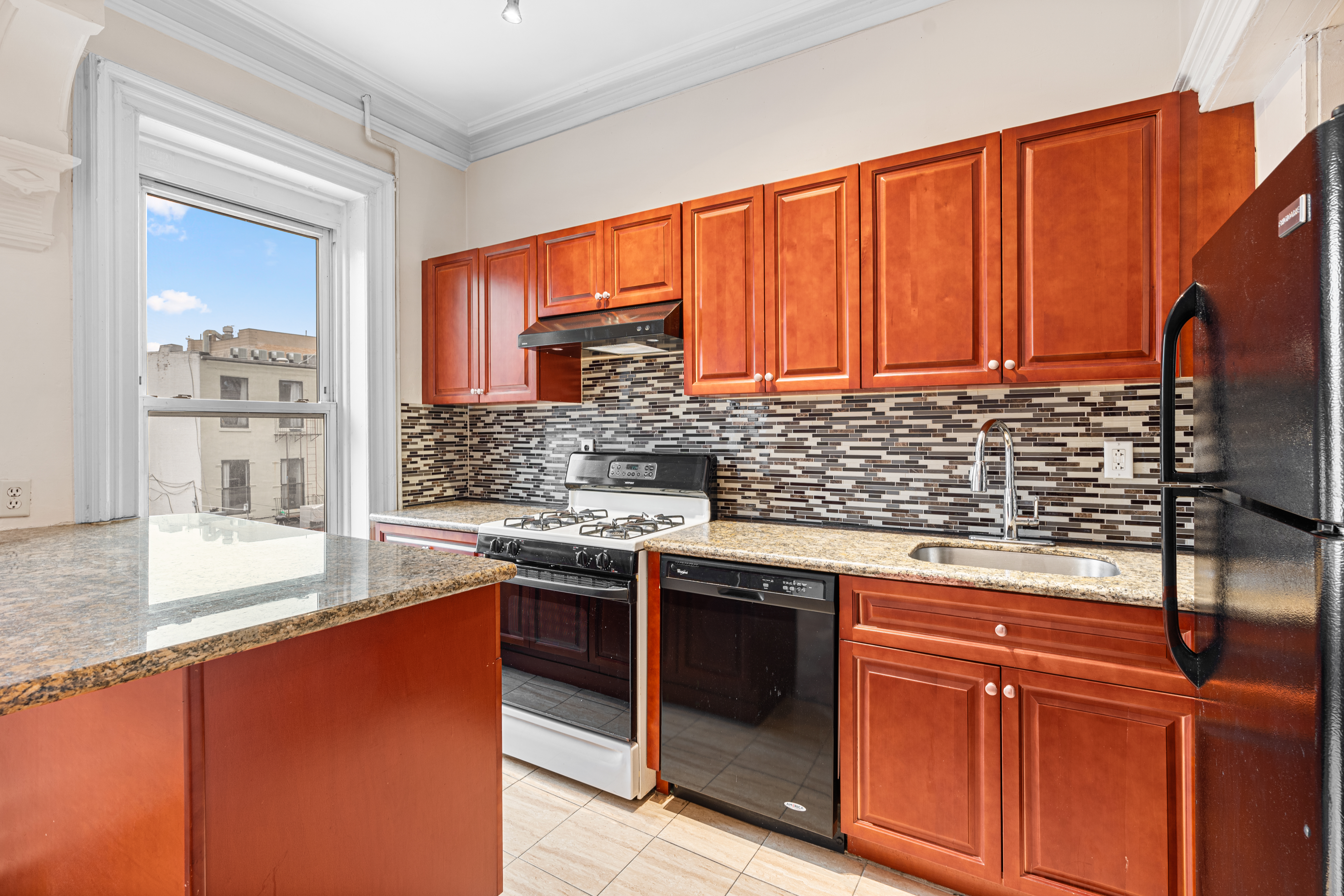 51 Herkimer Street, Unit 2 Brooklyn, NY 11216 - Photo 4 of 10 a kitchen with stainless steel appliances granite countertop a sink stove and cabinets
