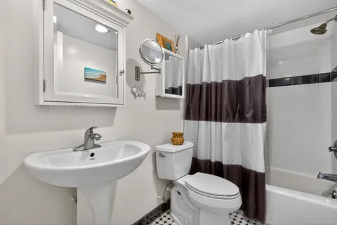 a white toilet sitting next to a bathroom sink