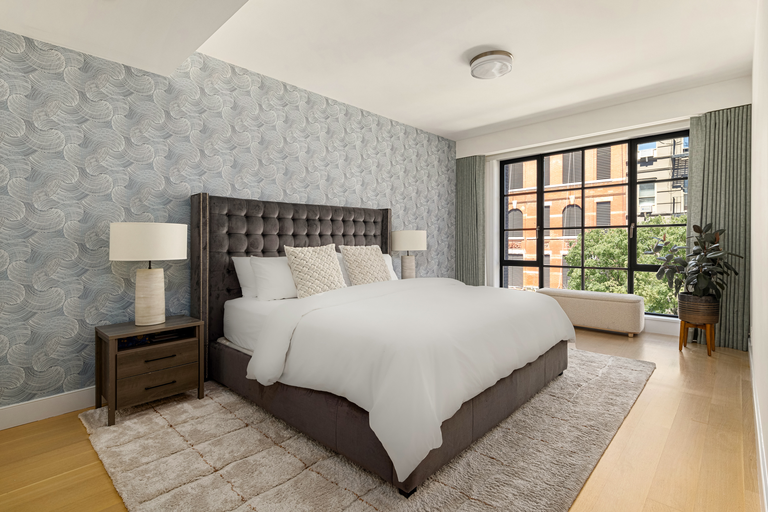 134 West 83rd Street, Unit 4 Manhattan, NY 10024 - Photo 8 of 17 a large bed sitting in a bedroom next to a window