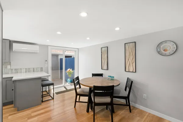 a view of a dining room with furniture and wooden floor