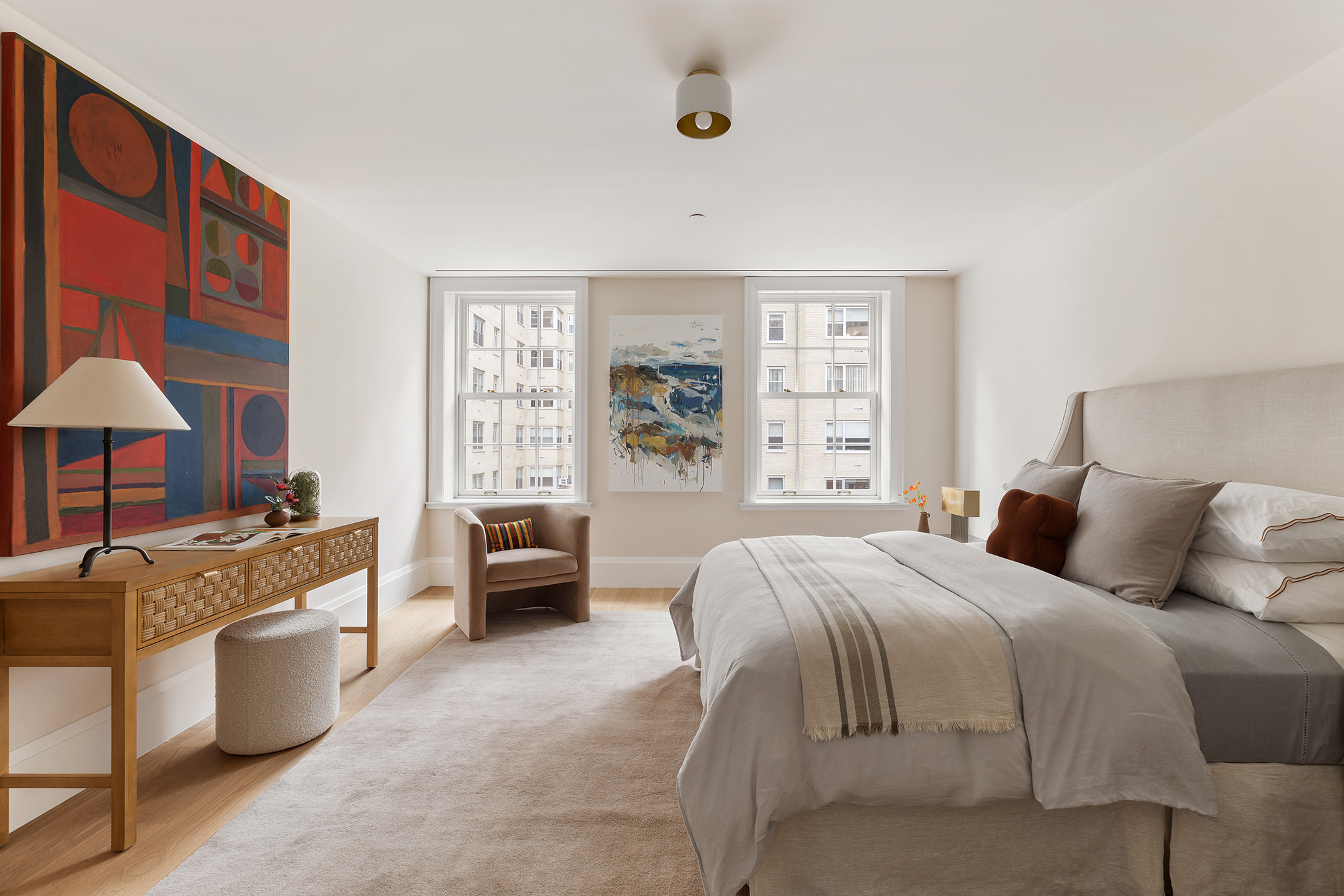 17 East 9th Street Manhattan, NY 10003 - Photo 20 of 32 a spacious bedroom with a large bed and a chandelier