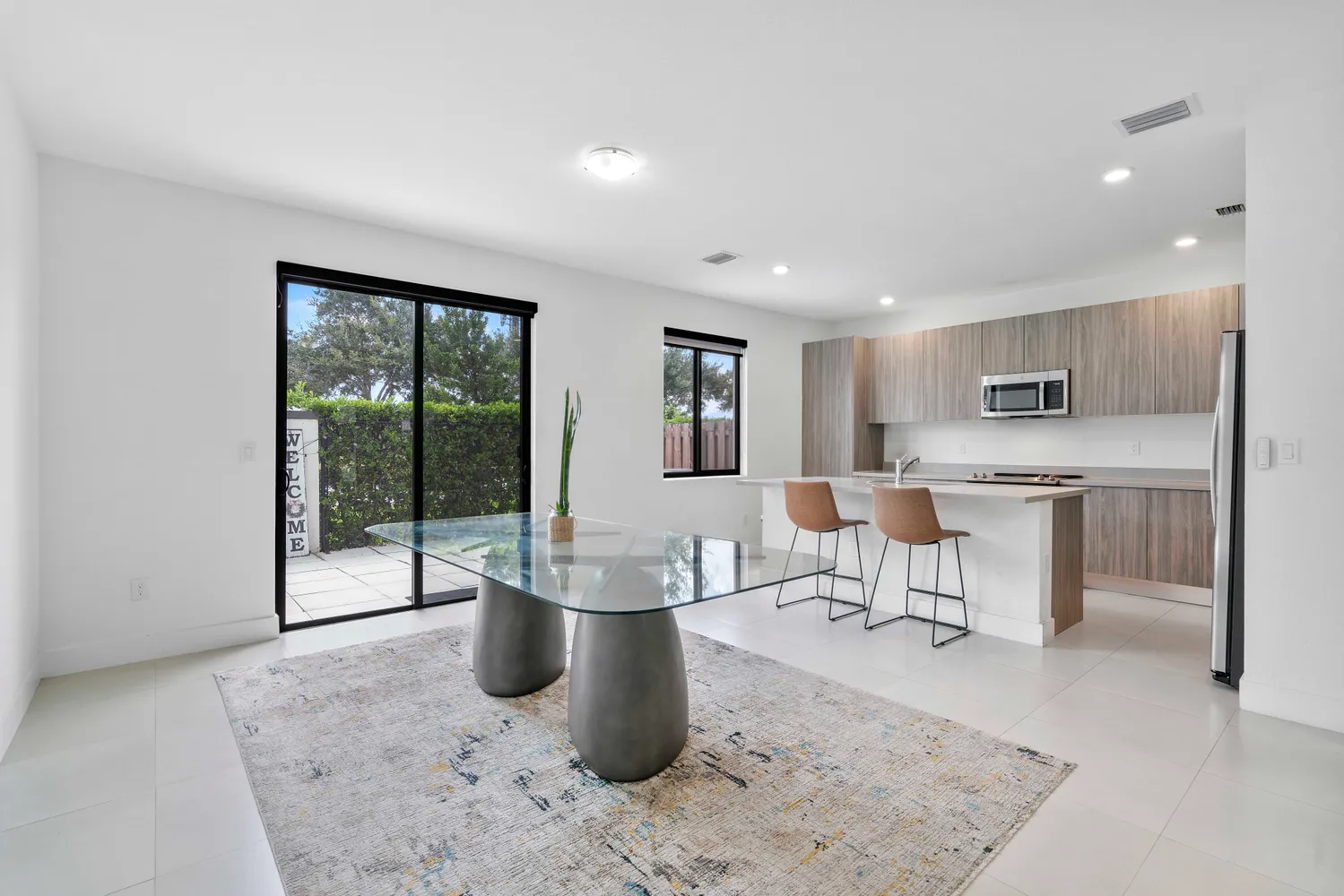 a living room with furniture a floor to ceiling window and outdoor view