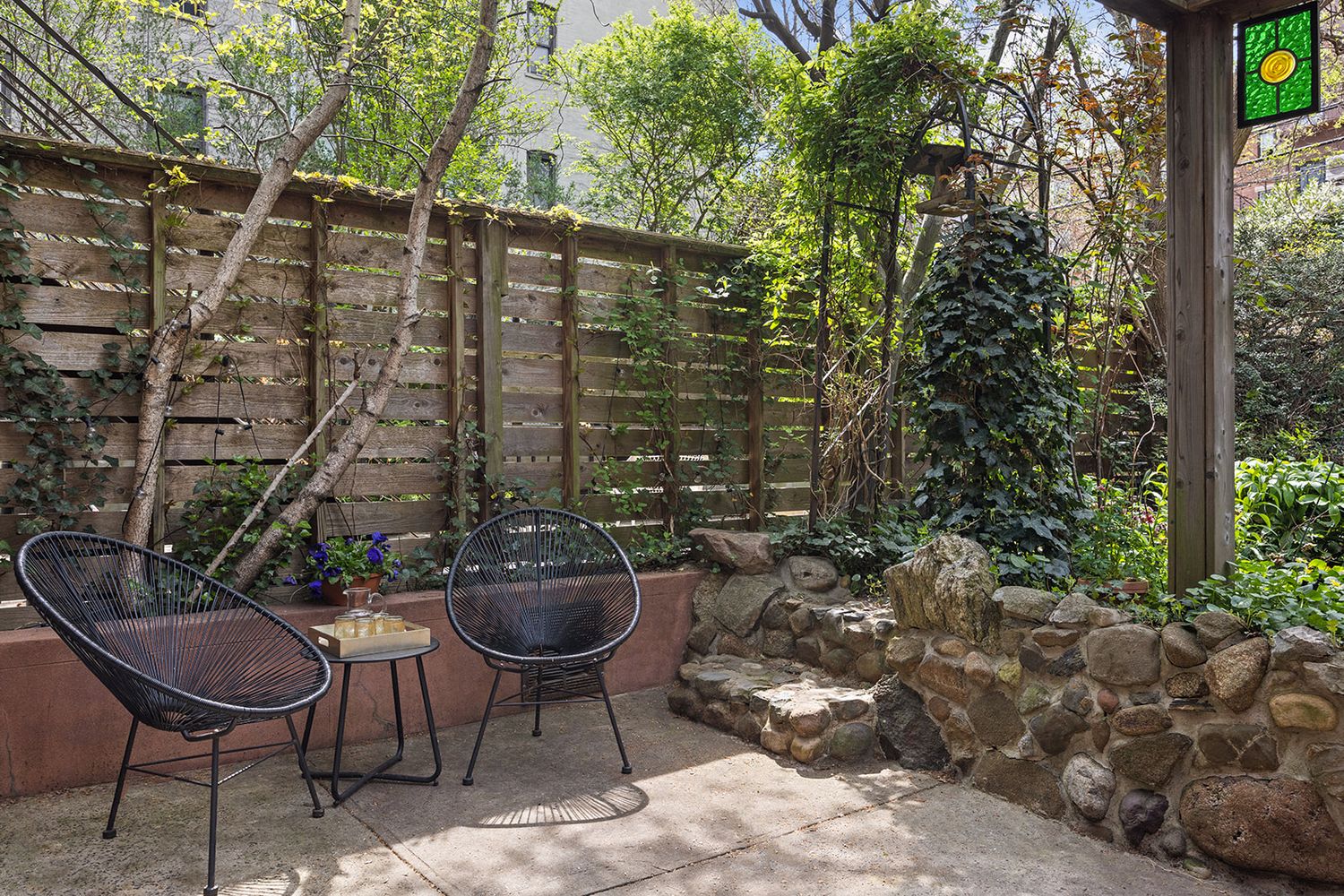 a backyard of a house with table and chairs