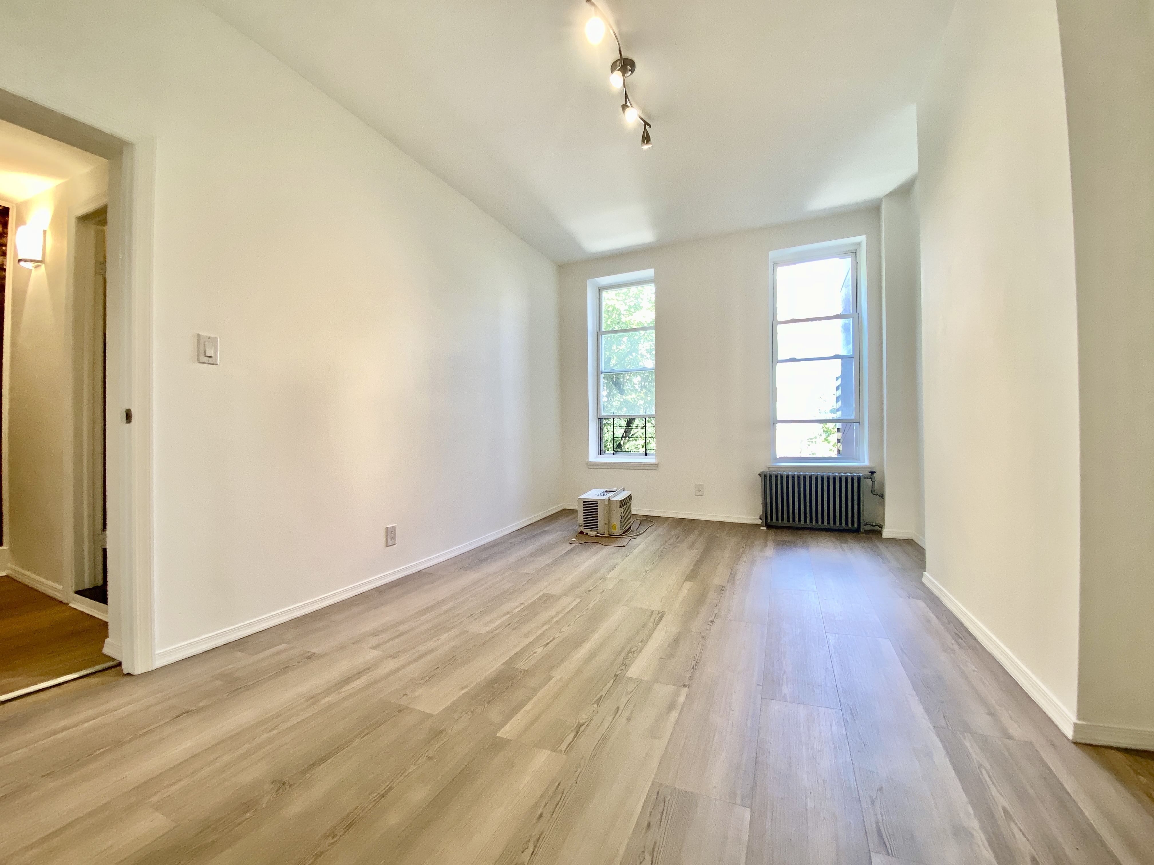 447 Degraw Street, Unit 1 Brooklyn, NY 11217 - Photo 7 of 11 an empty room with wooden floor and windows