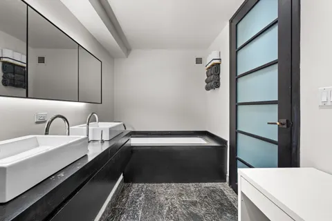 a bathroom with a bathtub and a sink
