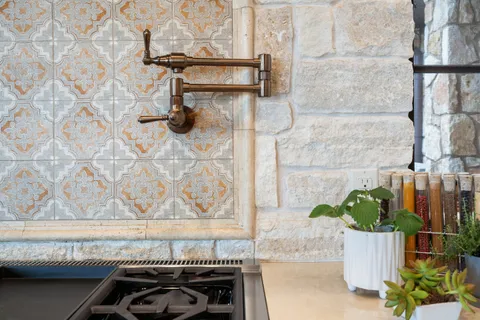 a view of a patio with table and chairs potted plants and large tree