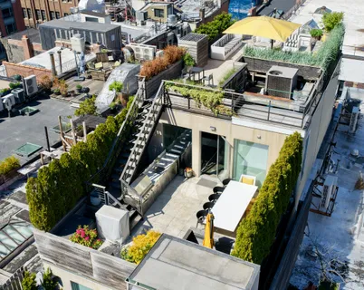 an aerial view of a house with outdoor seating