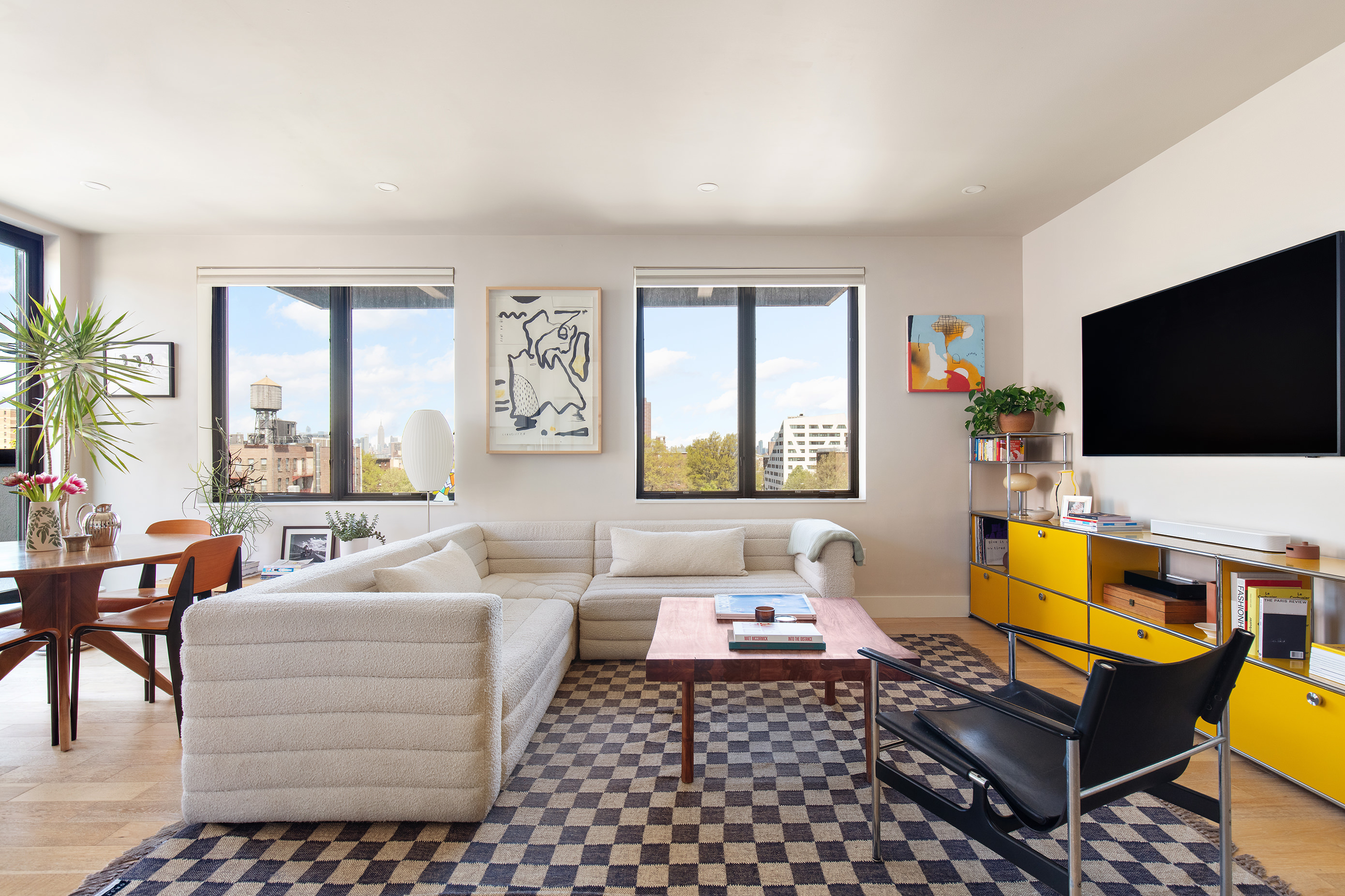 707 Willoughby Avenue, Unit 6B Brooklyn, NY 11206 - Photo 3 of 17 a living room with furniture and a flat screen tv