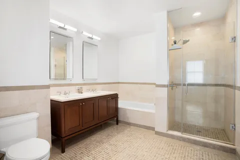 a bathroom with a sink vanity mirror and toilet