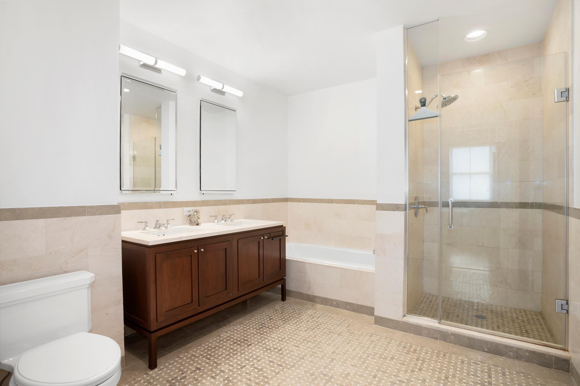 1 Hanson Place, Unit 16H Brooklyn, NY 11243 - Photo 5 of 21 a bathroom with a sink vanity mirror and toilet