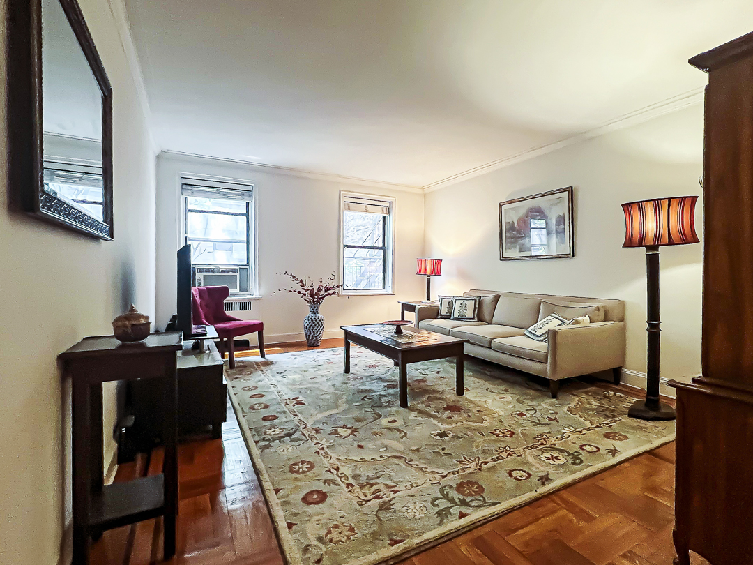 a living room with furniture and a rug