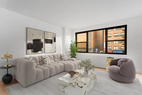 a living room with a large window and furniture