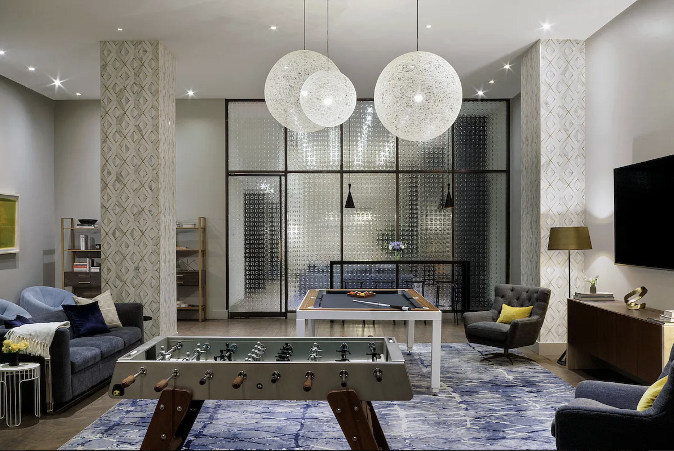 25 Broad Street, Unit 11K Manhattan, NY 10004 - Photo 10 of 16 a living room with furniture a mirror and a chandelier