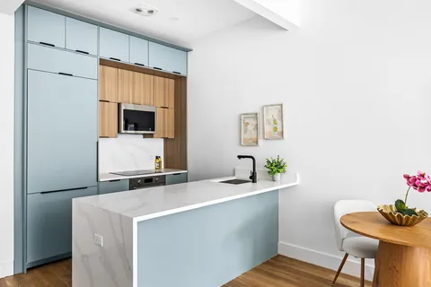 a room with a sink and a refrigerator