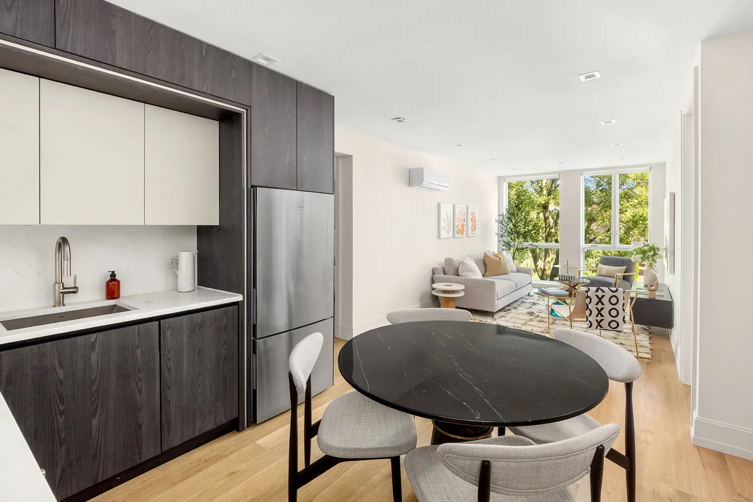 a kitchen with sink cabinets dining table and chairs