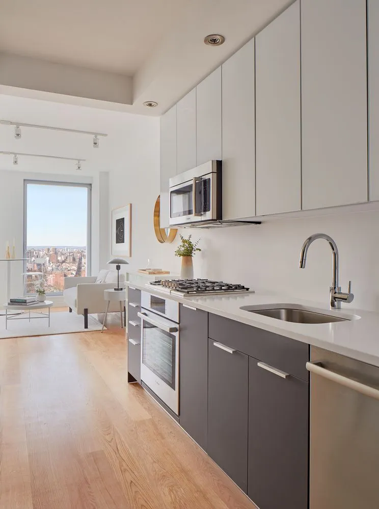a kitchen with stainless steel appliances granite countertop a stove sink and cabinets