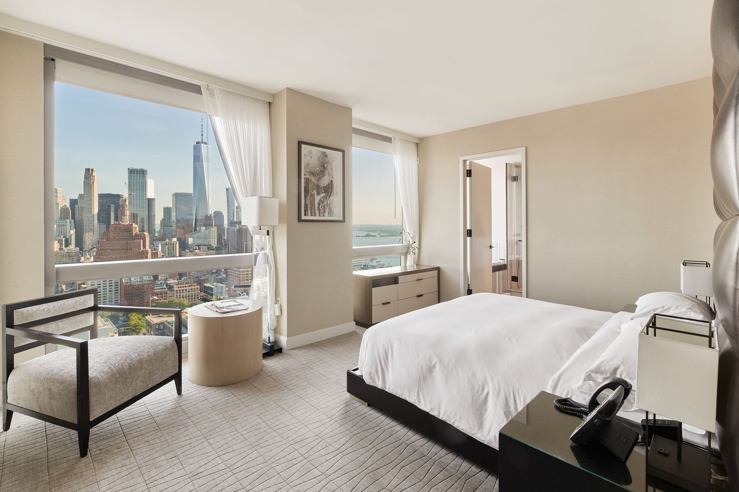 246 Spring Street, Unit 4104 Manhattan, NY 10013 - Photo 1 of 22 a bedroom with a bed and a couch