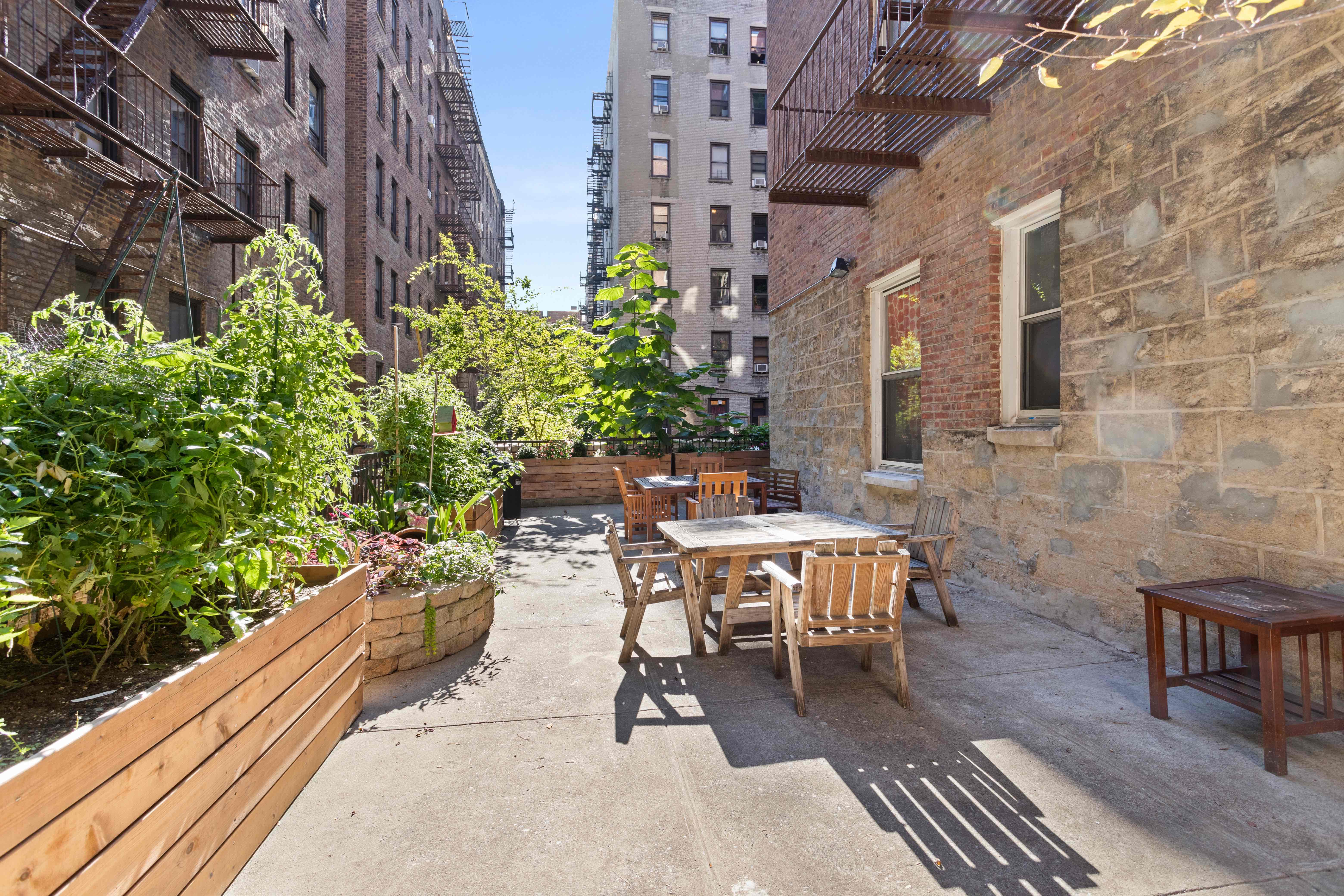 680 West 204th Street, Unit 5E Manhattan, NY 10034 - Photo 13 of 23 a view of a patio with table and chairs and potted plants