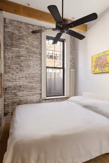 a view of a livingroom with a ceiling fan and window