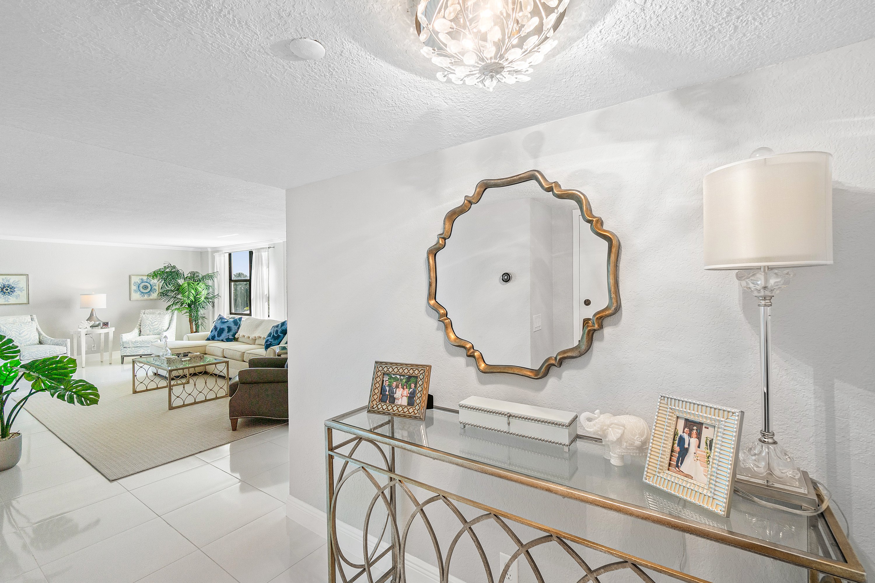 2003 North Ocean Boulevard, Unit 305 Boca Raton, FL 33431 - Photo 6 of 56 a living room with furniture and a mirror