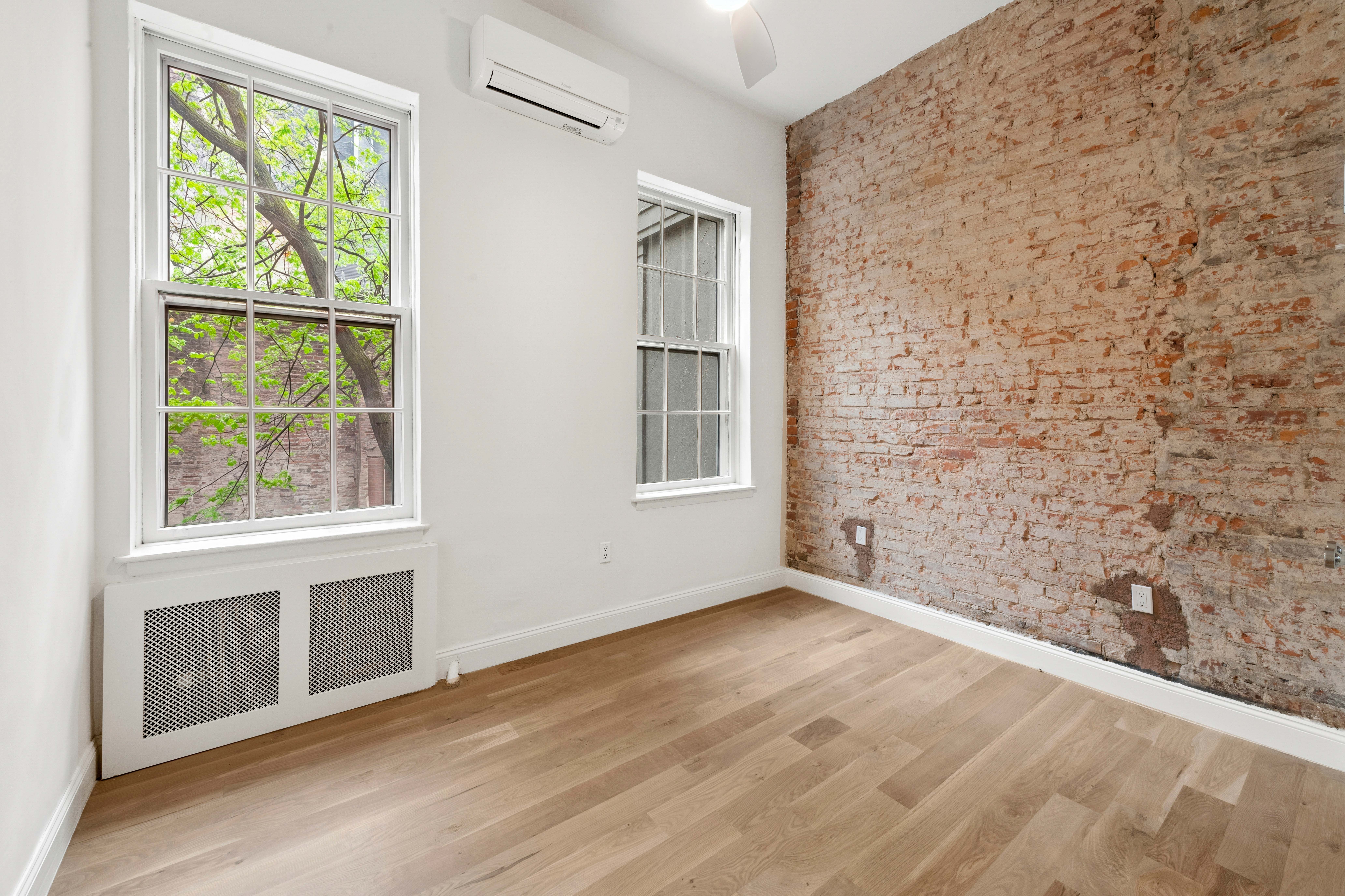 765 Greenwich Street, Unit 1 Manhattan, NY 10014 - Photo 9 of 14 a view of an empty room with wooden floor and a window