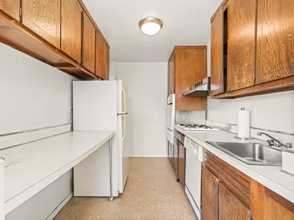 a kitchen with stainless steel appliances granite countertop a sink and a refrigerator