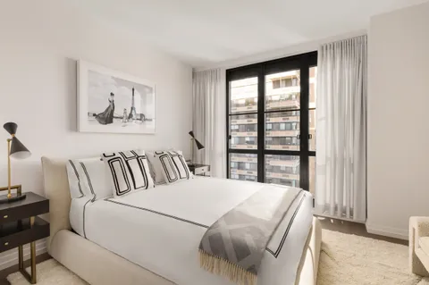 a bedroom with a large bed and a window