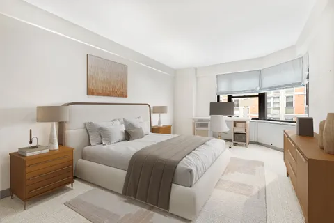 a bedroom with a bed and a view of kitchen