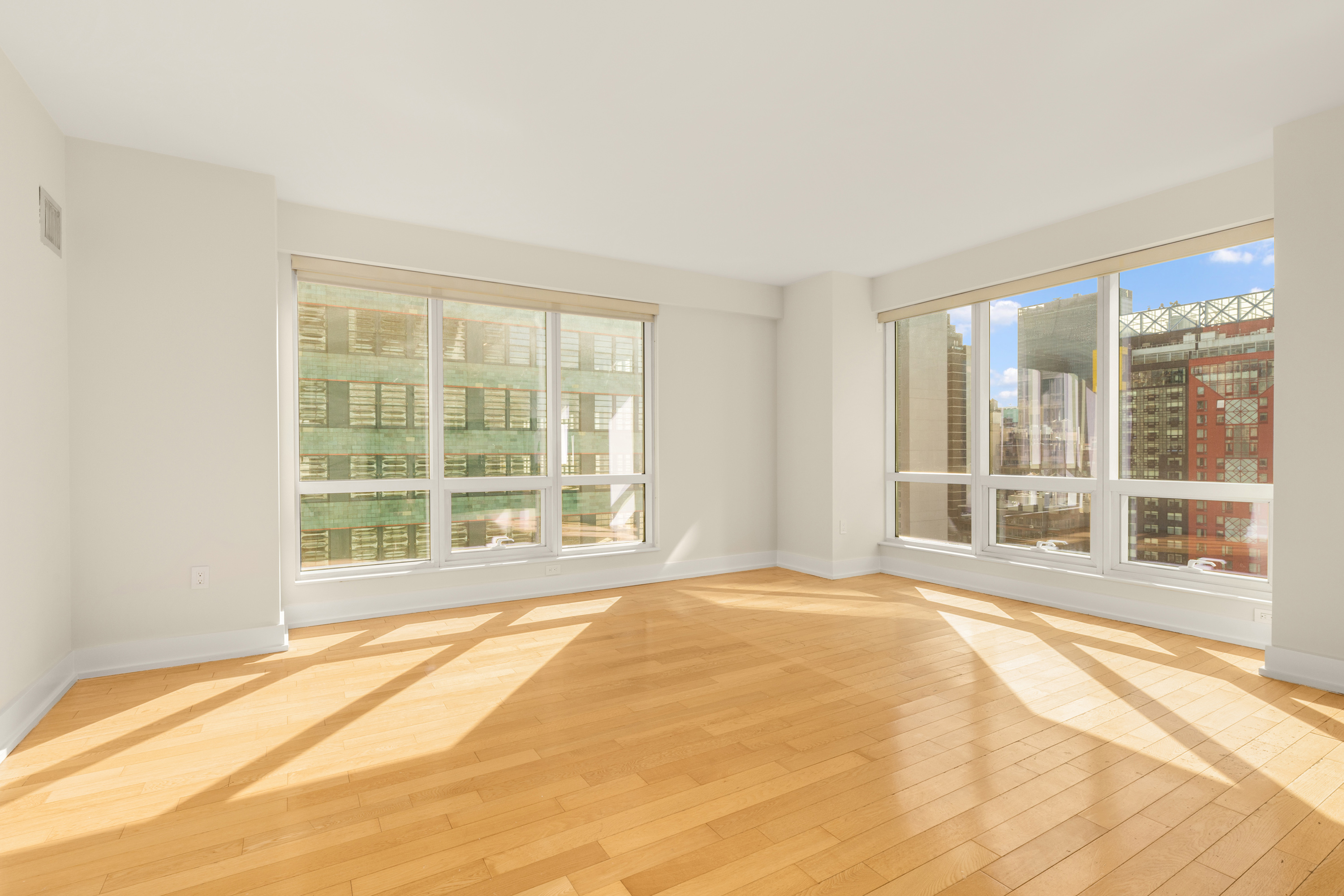 350 West 42nd Street, Unit 26G Manhattan, NY 10036 - Photo 2 of 11 a view of a bedroom with a bed and wooden floor