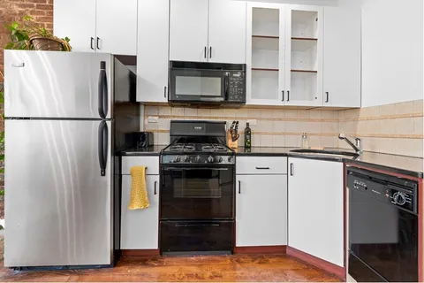 a kitchen with stainless steel appliances a refrigerator stove and microwave
