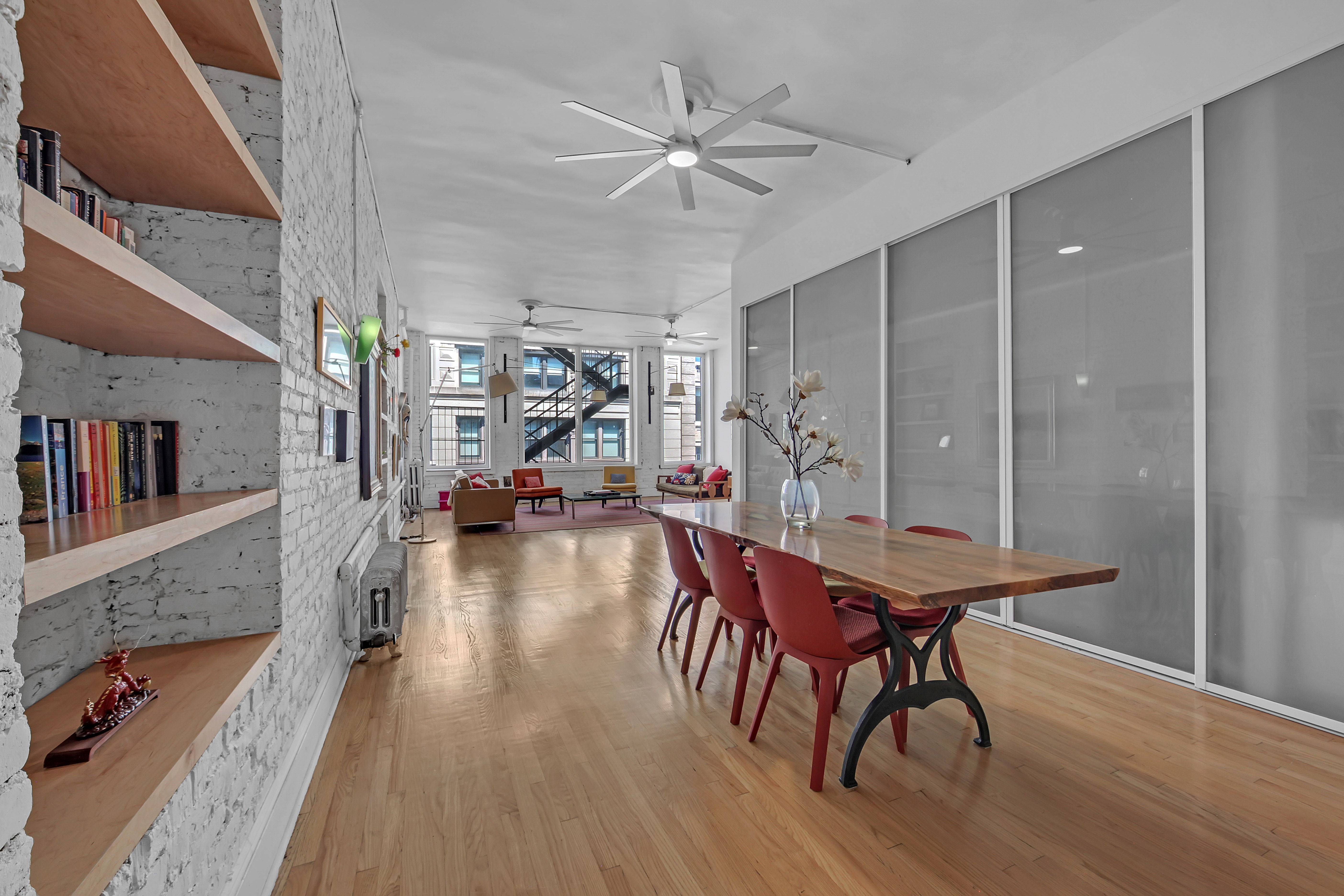 56 East 11th Street, Unit 7 Manhattan, NY 10003 - Photo 4 of 18 a view of a dining room with furniture and a chandelier fan