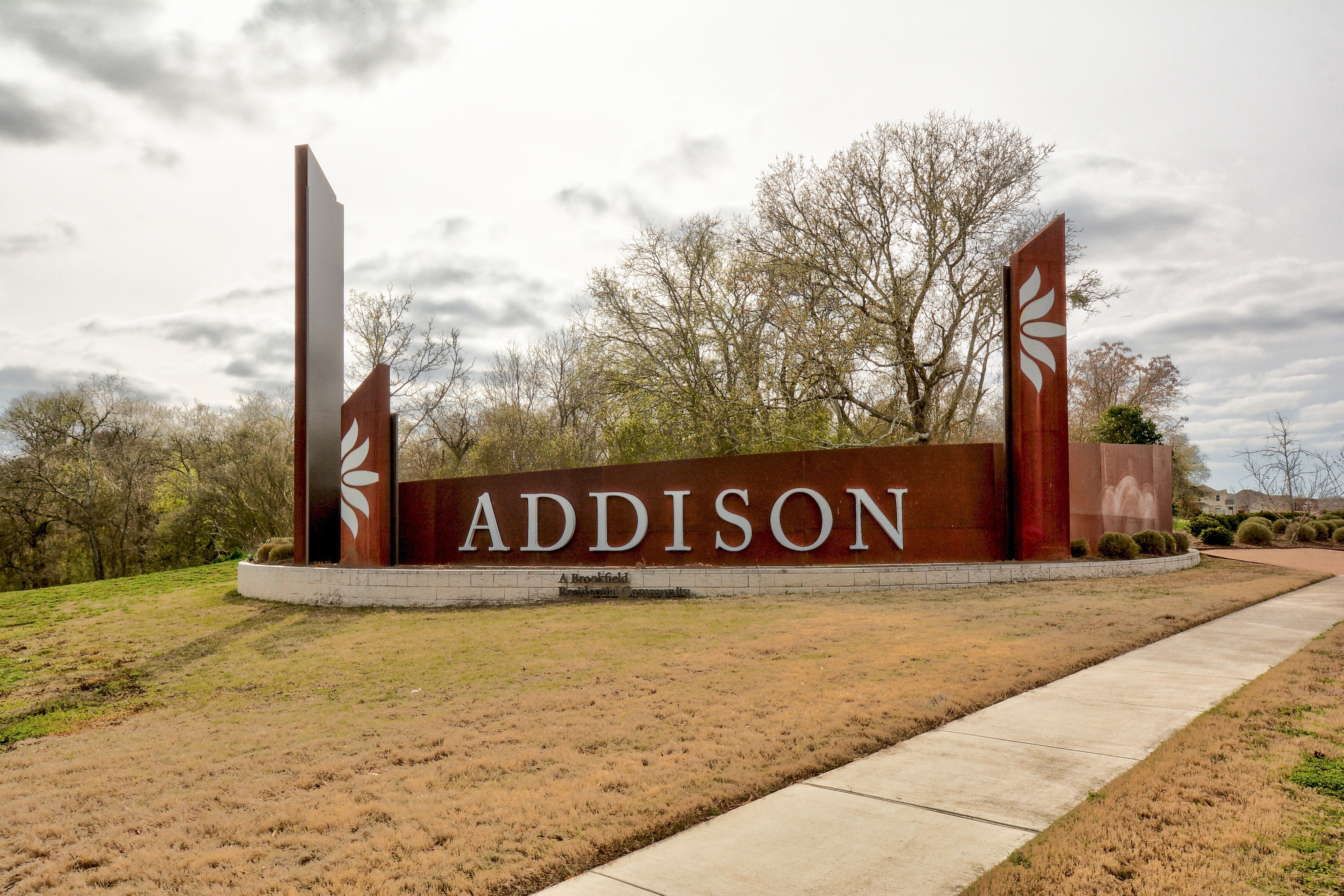 5400 Daimler Drive Austin, TX 78744 - Photo 24 of 27 a street sign on a sidewalk next to a road