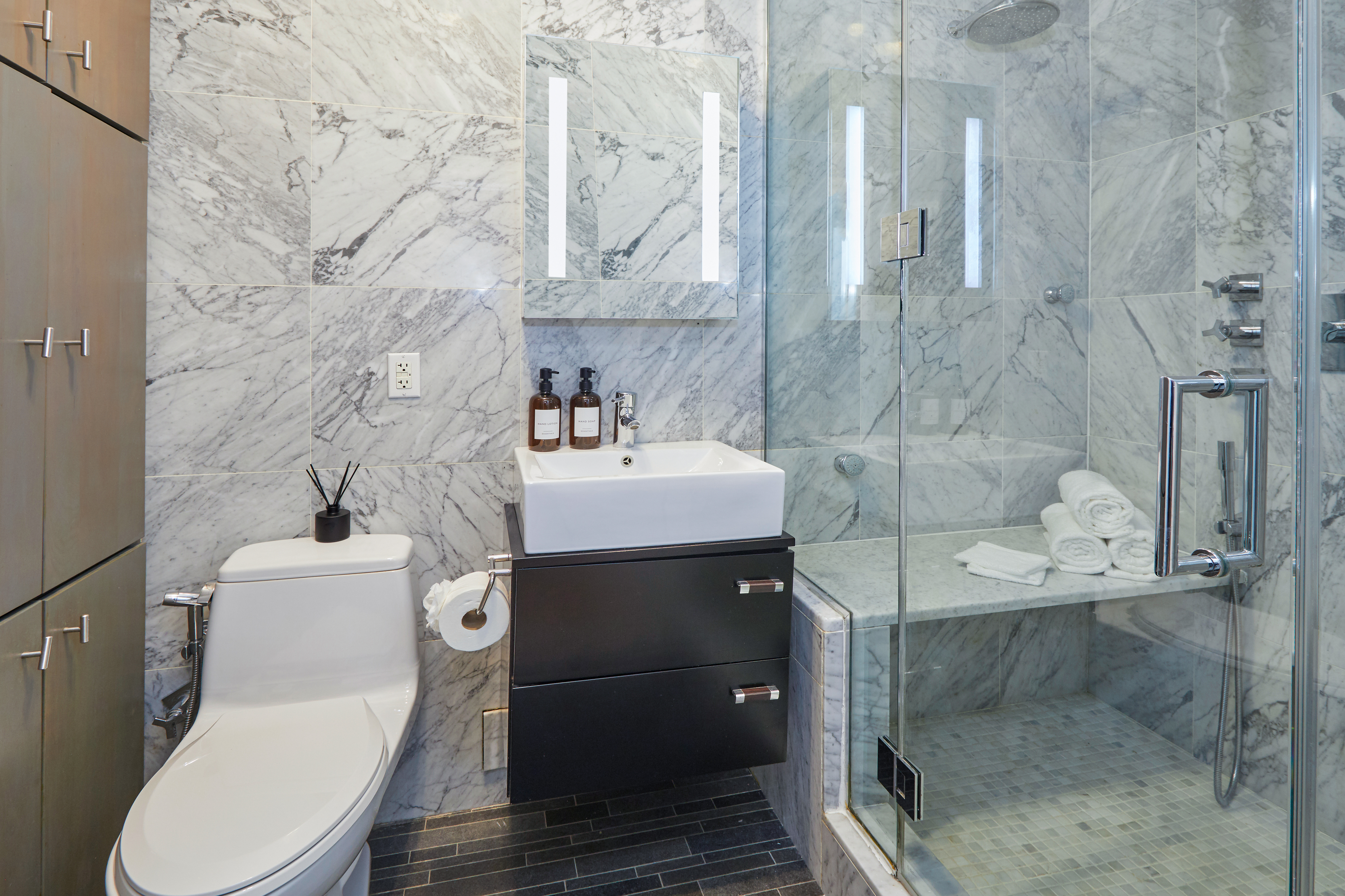 80 Leonard Street, Unit 3G Manhattan, NY 10013 - Photo 25 of 30 a bathroom with a sink toilet and shower