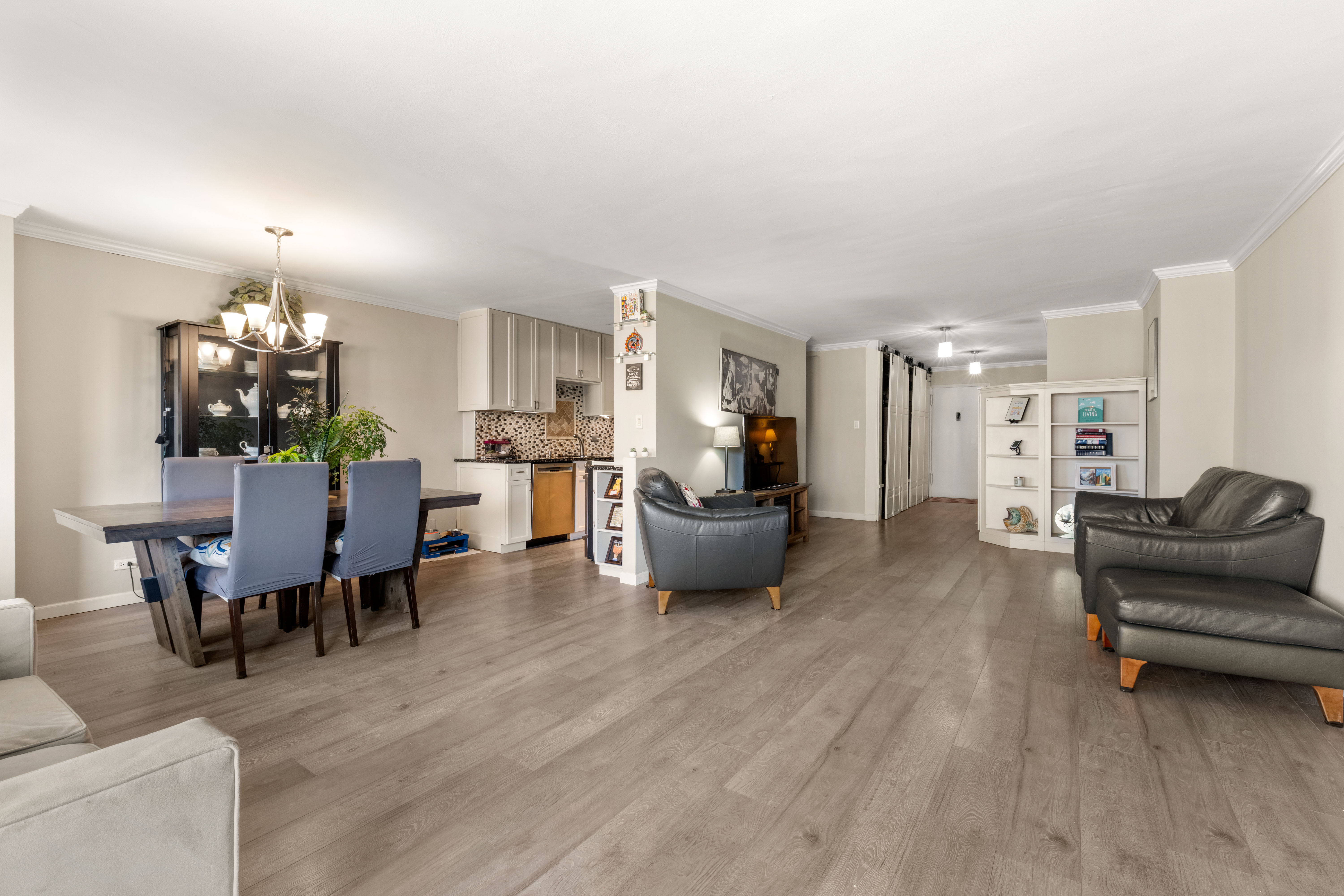 102-30 66th Road, Unit 7E Queens, NY 11375 - Photo 4 of 15 a living room with furniture and kitchen view