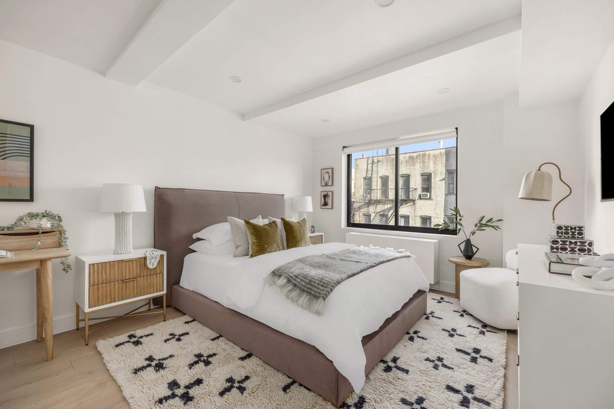 533 East 12th Street, Unit 6D Manhattan, NY 10009 - Photo 9 of 14 a bedroom with a bed and a couch