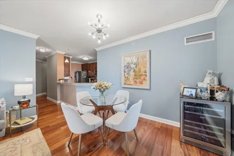 a view of a dining room with furniture and wooden floor