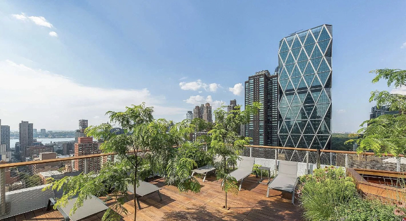301 West 53rd Street, Unit 8J Manhattan, NY 10019 - Photo 8 of 14 a view of balcony with a potted plants and wooden fence