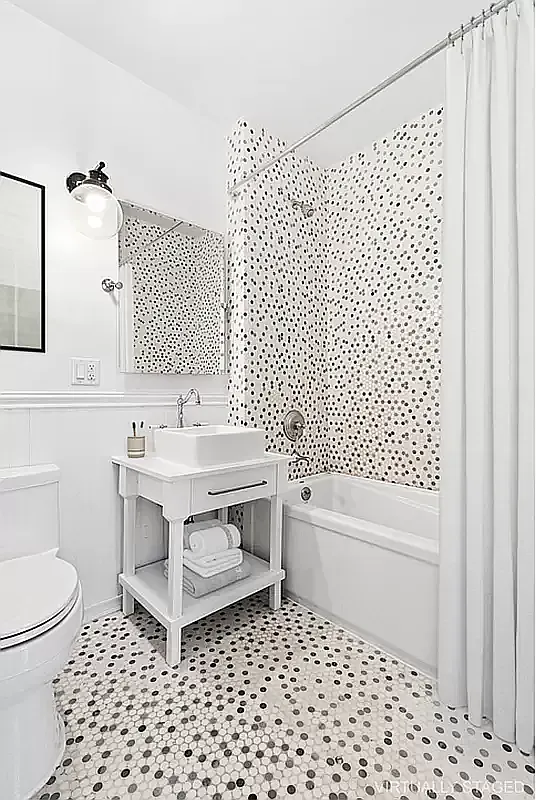 180 Bainbridge Street, Unit 401 Brooklyn, NY 11233 - Photo 6 of 23 a bathroom with a sink a toilet and a shower