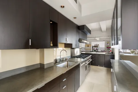 a kitchen with counter top space and cabinets