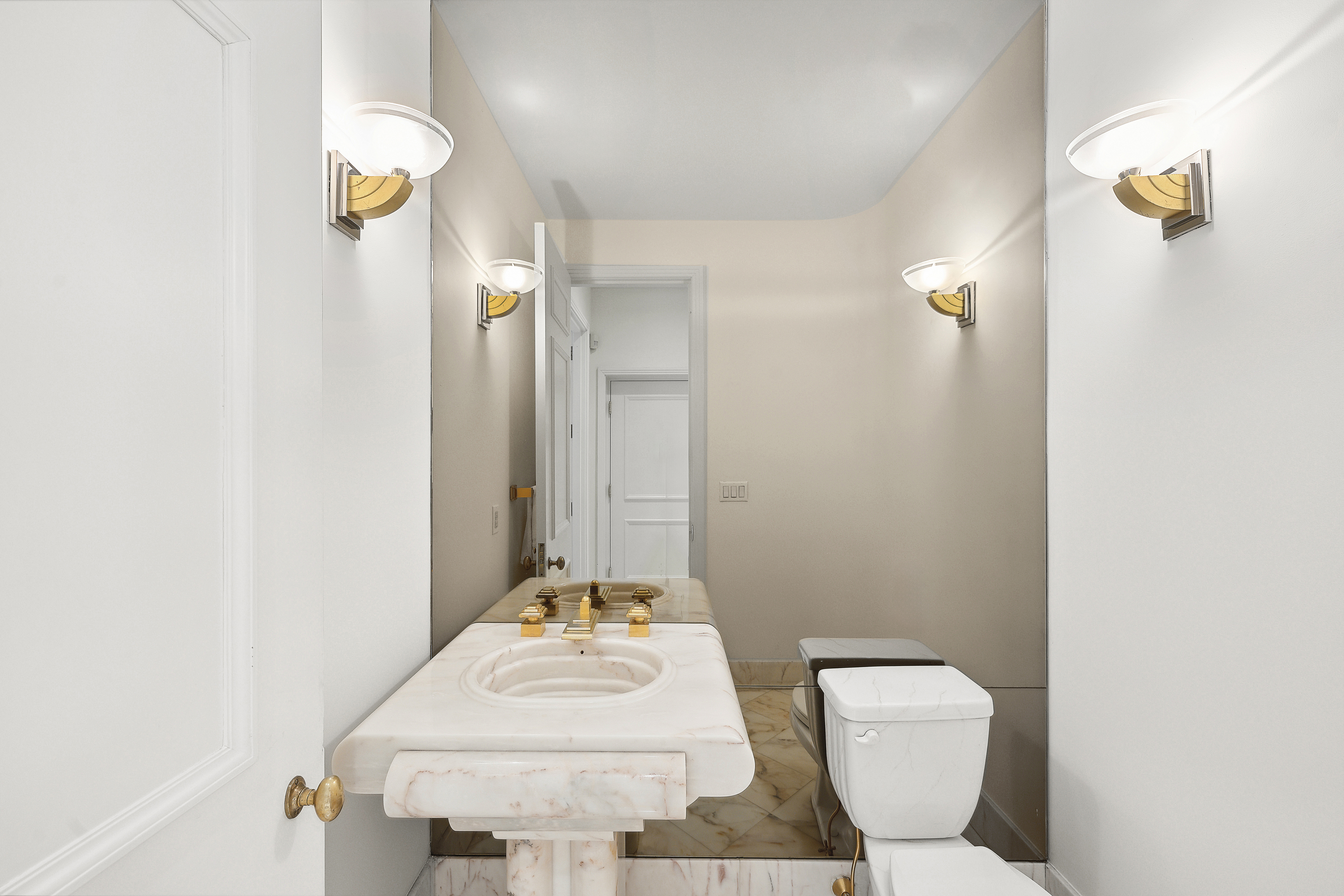 50 East 73rd Street Manhattan, NY 10021 - Photo 26 of 32 a bathroom with a toilet sink and mirror