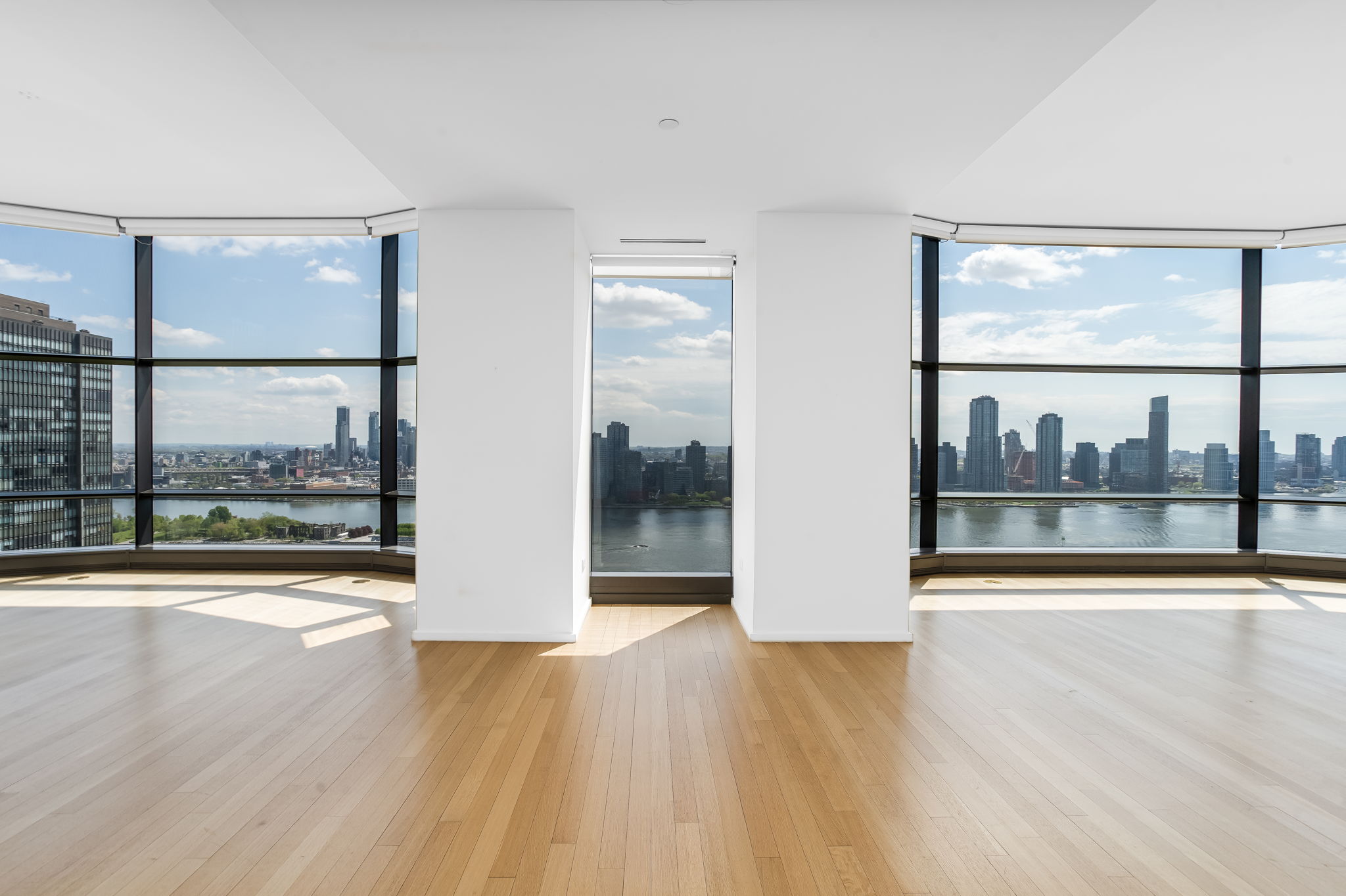 50 United Nations Plaza, Unit 26B Manhattan, NY 10017 - Photo 1 of 25 a view of an empty room with wooden floor and a window