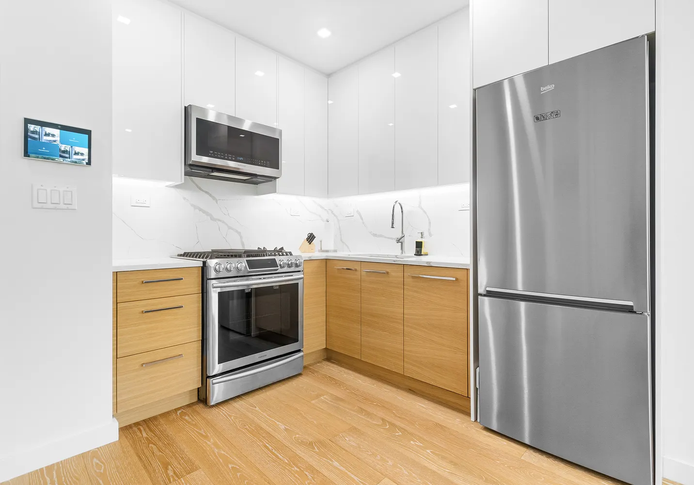 a kitchen with stainless steel appliances a refrigerator stove and microwave