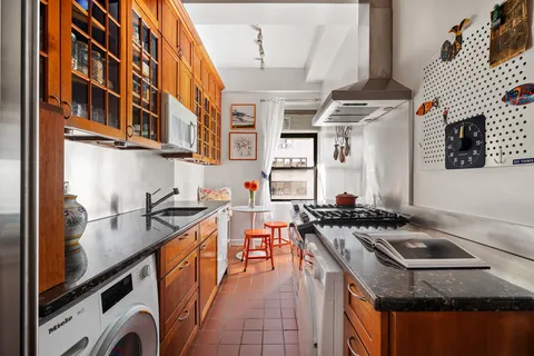 a kitchen with stainless steel appliances granite countertop a stove and a sink