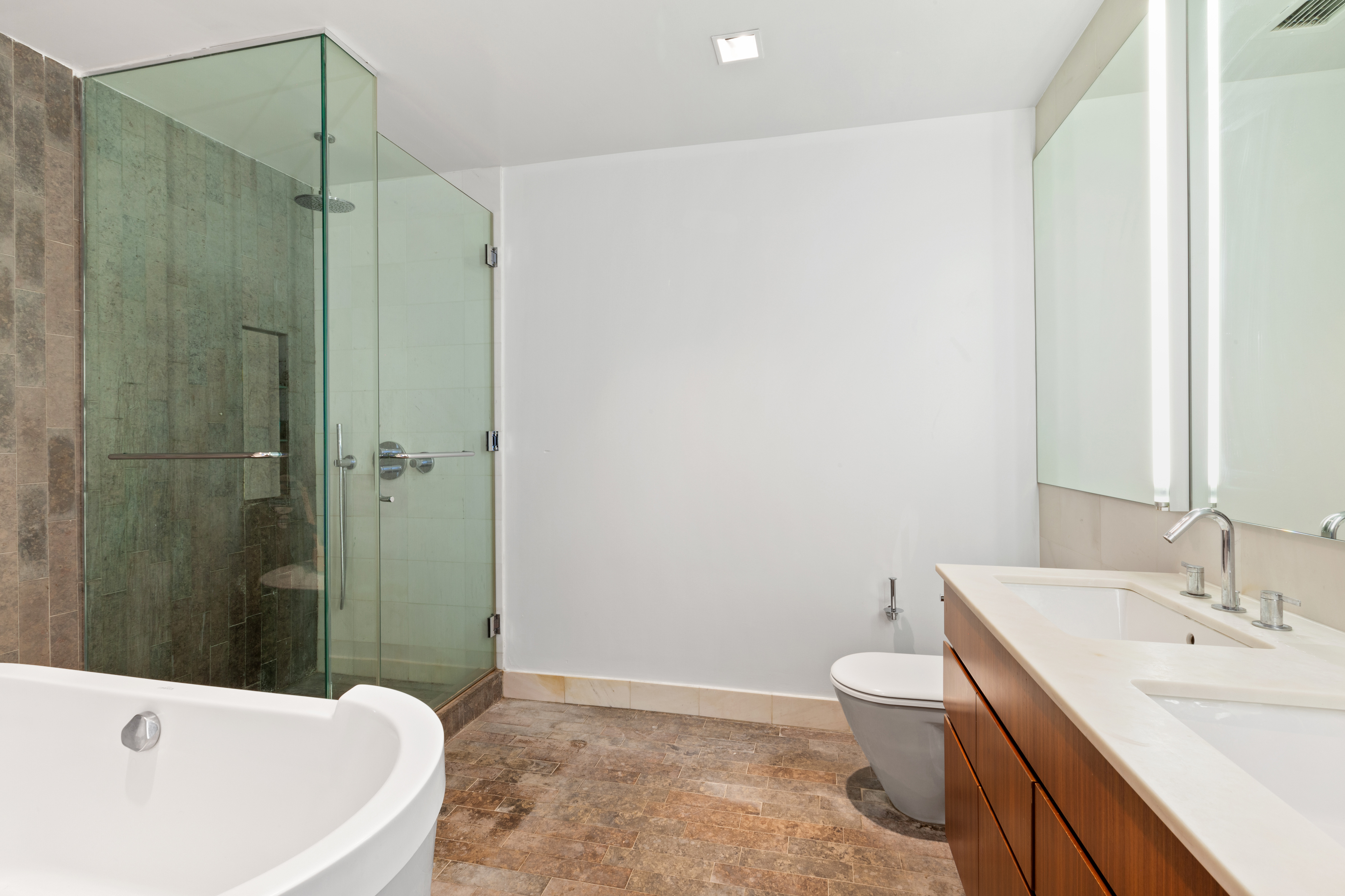 447 West 18th Street, Unit 7A Manhattan, NY 10011 - Photo 8 of 16 a bathroom with a sink a toilet and shower