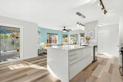 a living room with kitchen island and furniture