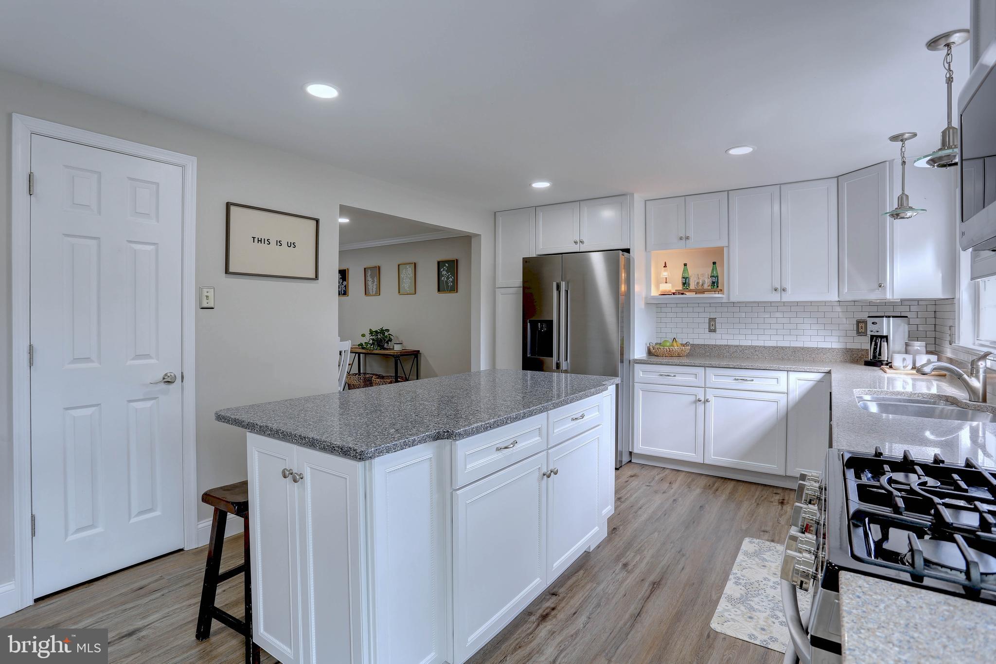 6257 Fairbourne Court Hanover, MD 21076 - Photo 10 of 47 a kitchen with white cabinets and stainless steel appliances