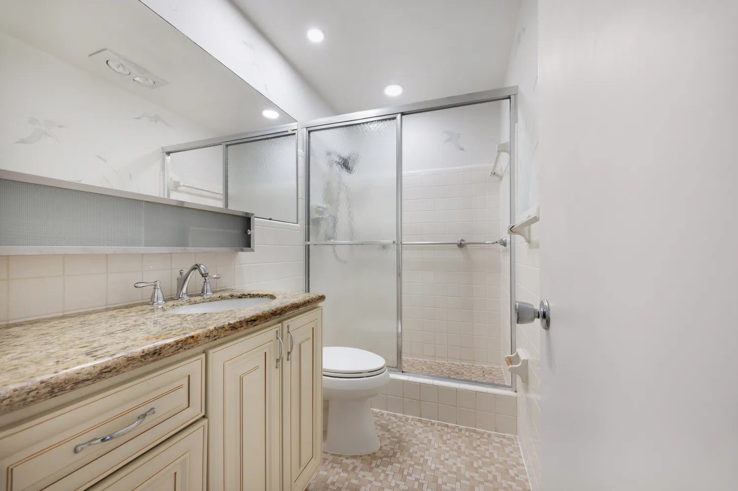 a view of a swimming pool with a table and chairs under an umbrella